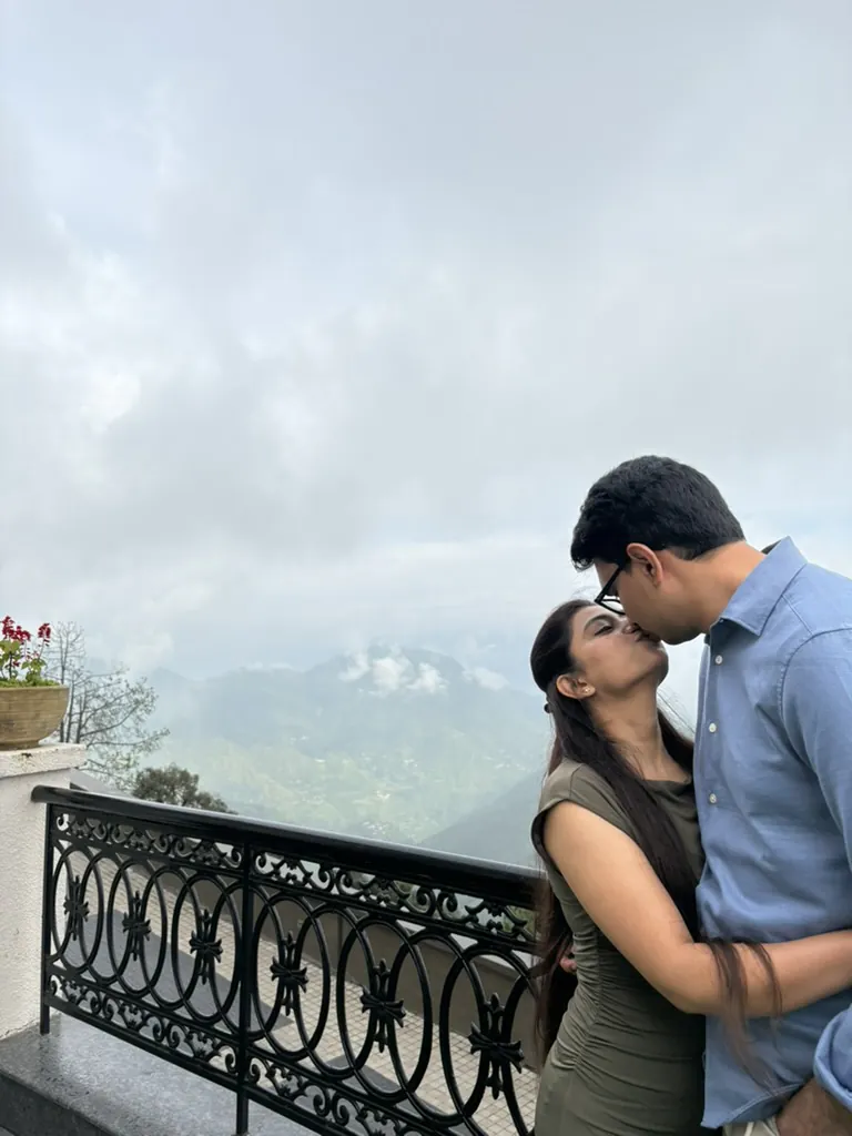 A kiss on the terrace with misty mountains behind us